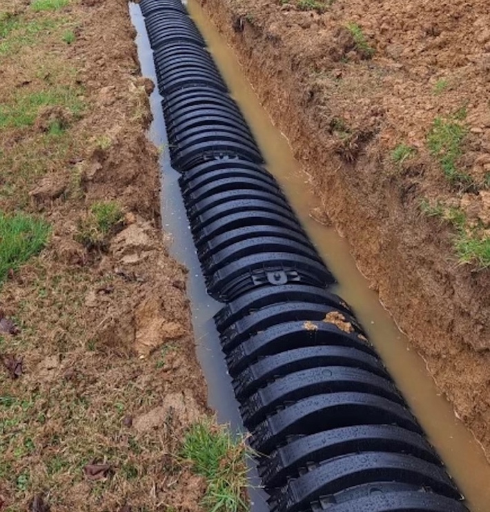 A black pipes in a ditch

Description automatically generated